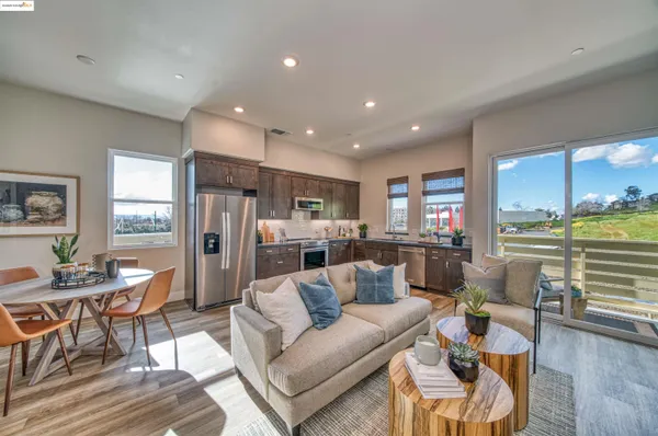a living room with furniture and kitchen view