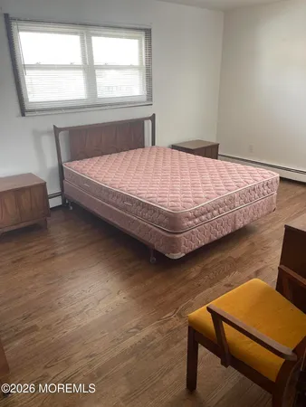 a bedroom with a bed chair and a window