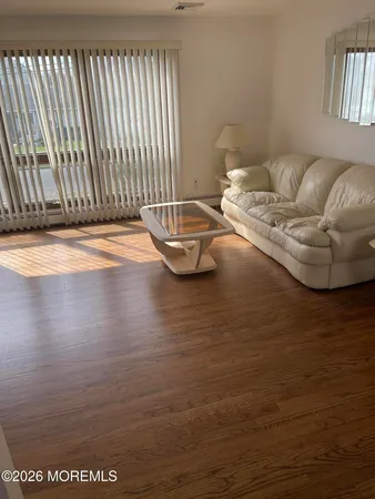 a living room with furniture and a floor to ceiling window