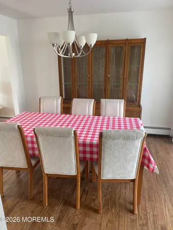 a dining room with furniture and wooden floor