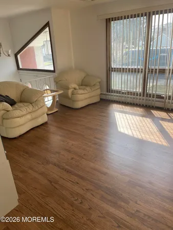 a living room with furniture and a floor to ceiling window