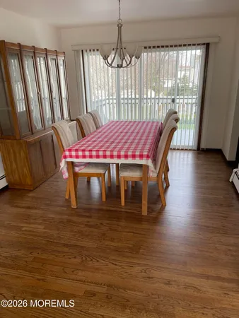 a dining room with furniture wooden floor and a rug