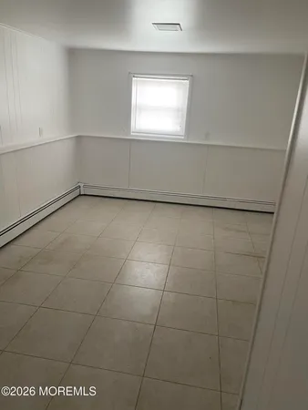 a view of a room with an empty space and window