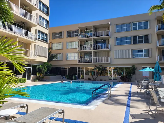 a view of swimming pool with outdoor seating