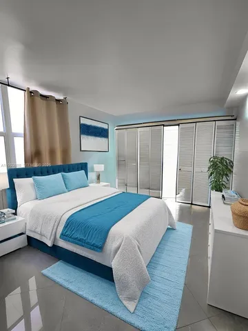 a bedroom with a large bed and a large window