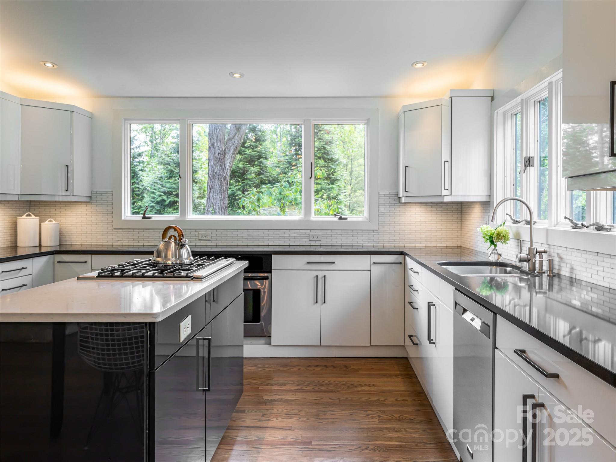 5 Busbee Road Asheville, NC 28803 - Photo 11 of 48 a kitchen with a sink stove and cabinets