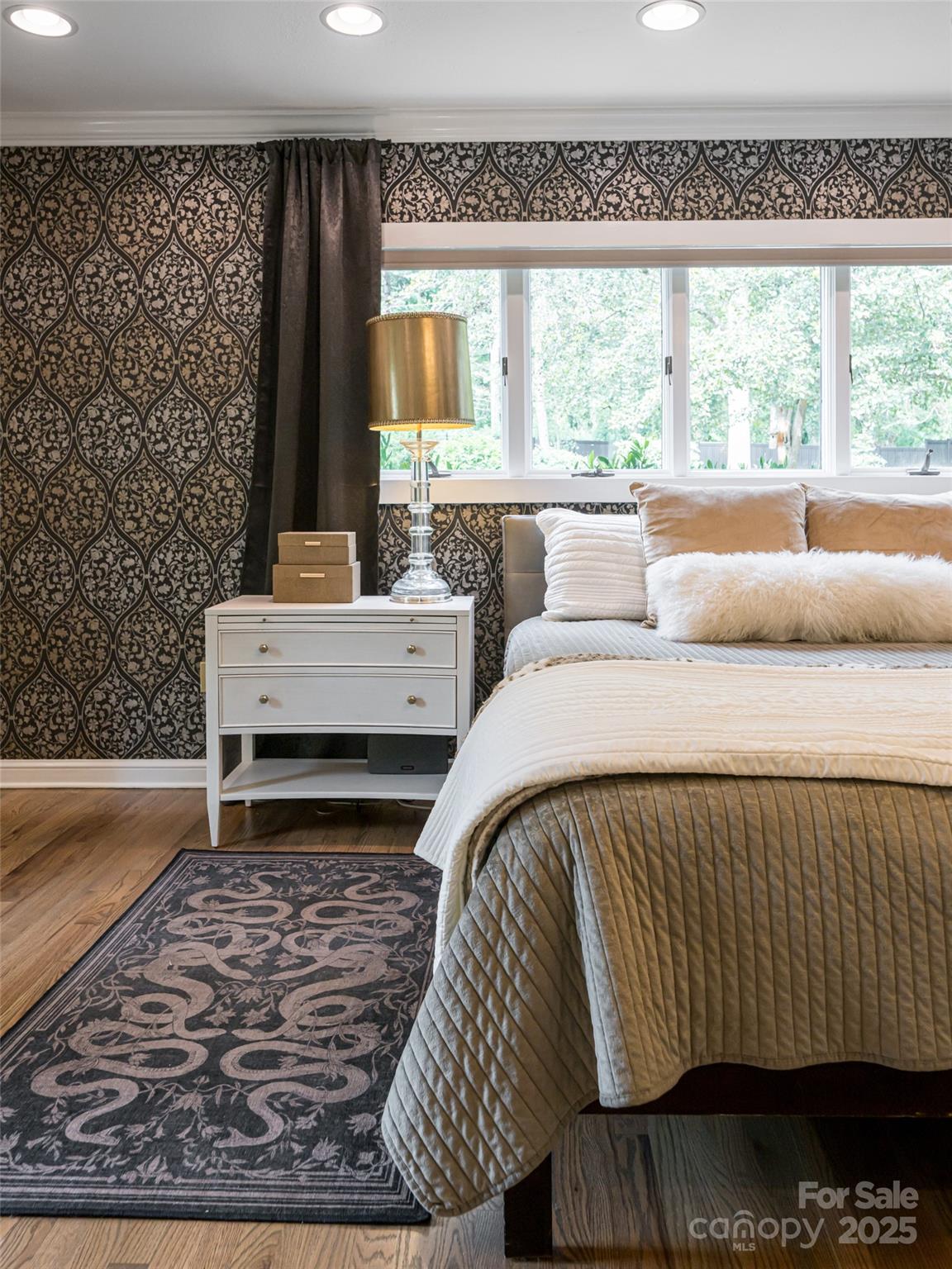 5 Busbee Road Asheville, NC 28803 - Photo 16 of 48 a bed sitting in a bedroom next to a window with a rug
