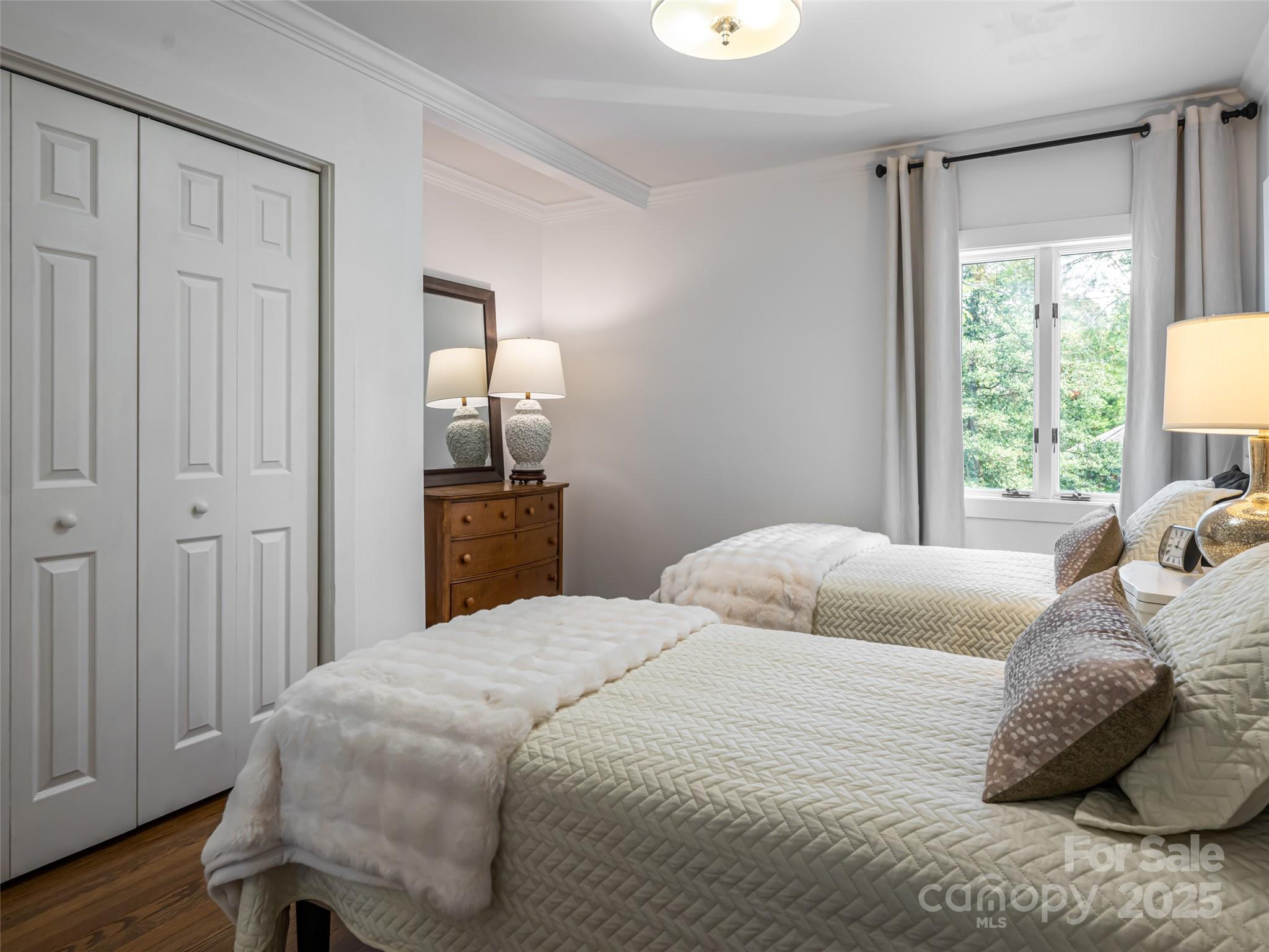 5 Busbee Road Asheville, NC 28803 - Photo 34 of 48 a bedroom with a bed and wooden floor