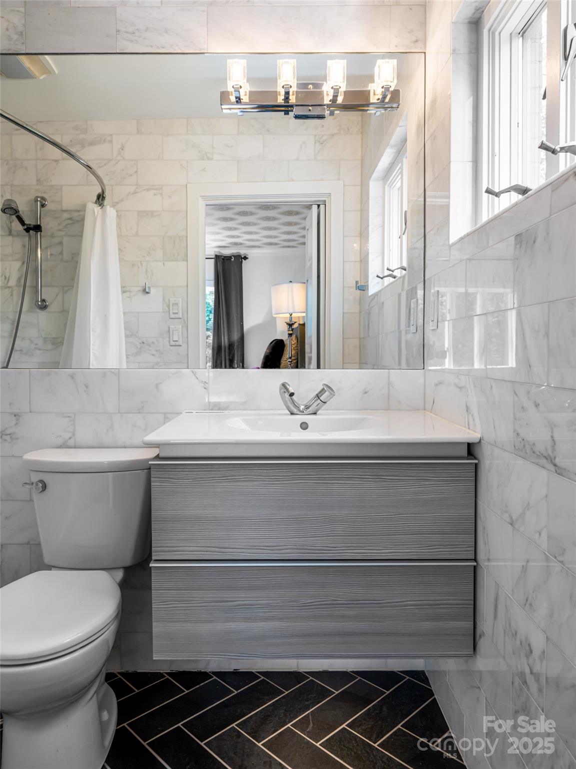 5 Busbee Road Asheville, NC 28803 - Photo 36 of 48 a bathroom with a sink and a mirror
