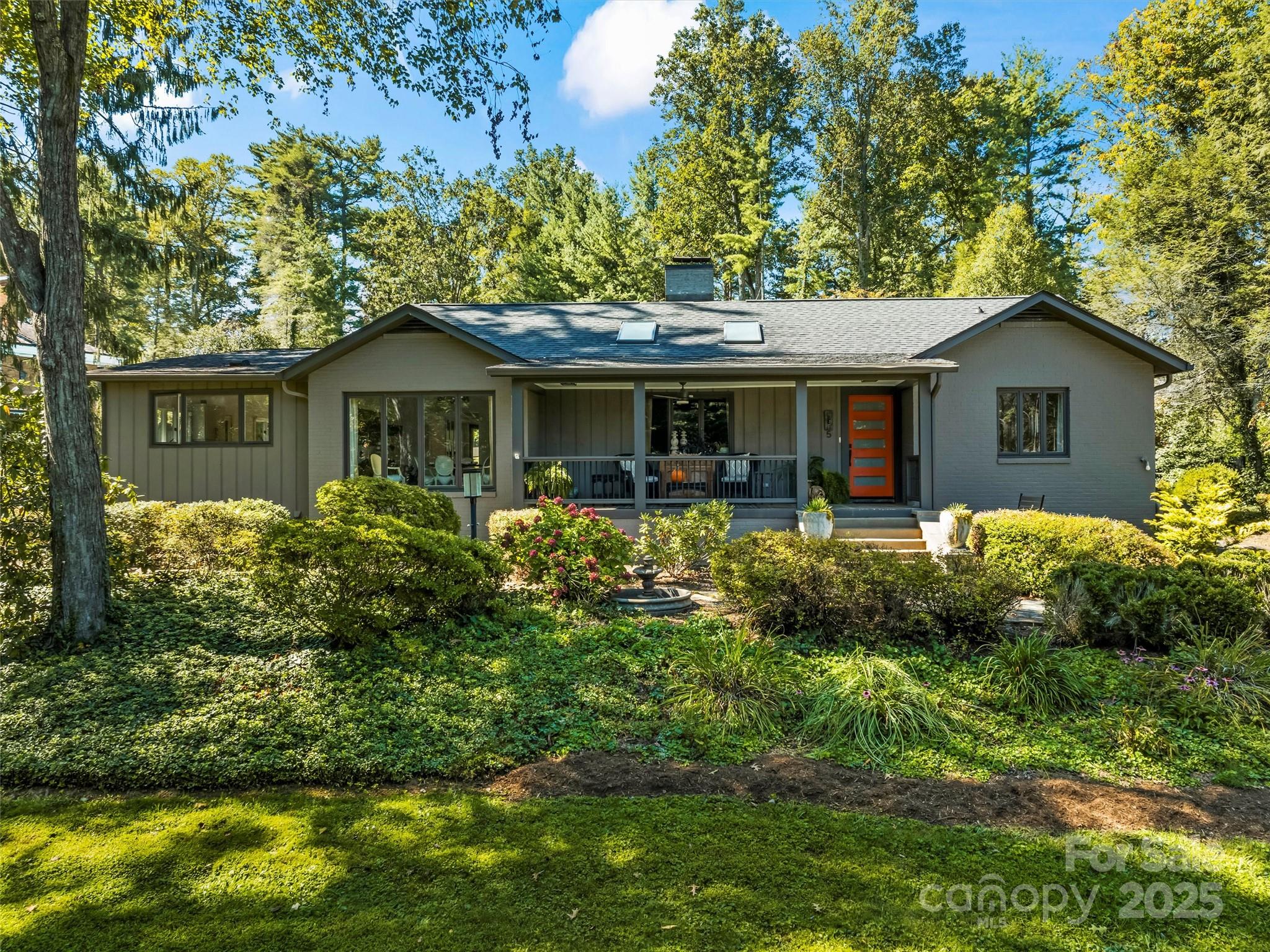 5 Busbee Road Asheville, NC 28803 - Photo 40 of 48 a front view of a house with a yard and potted plants