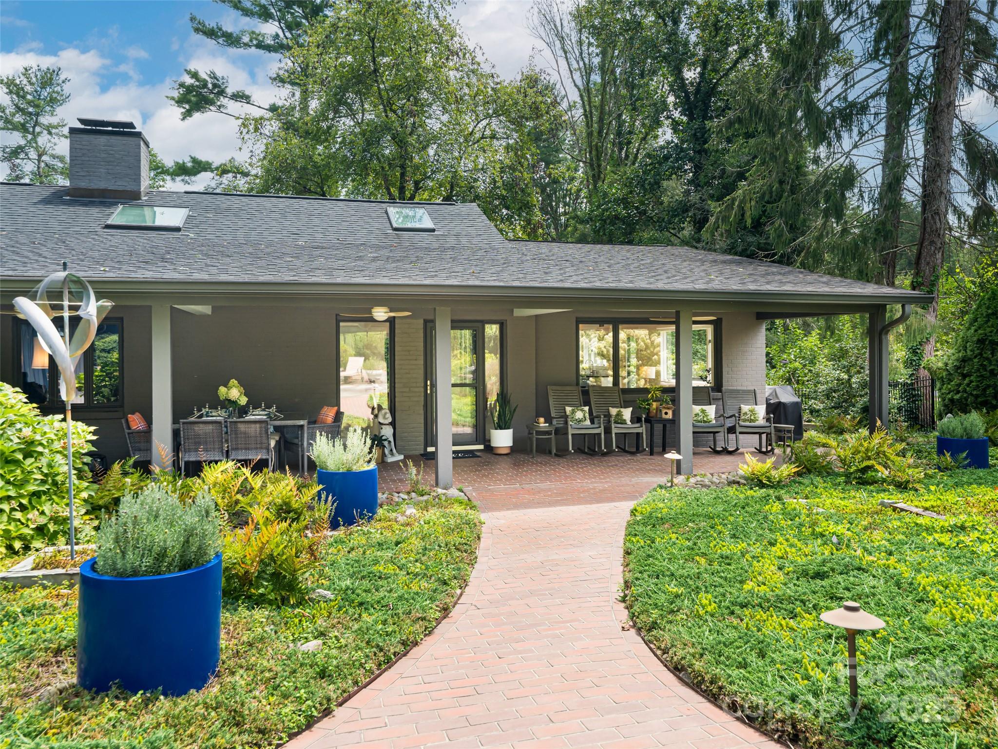 5 Busbee Road Asheville, NC 28803 - Photo 4 of 48 a house view with a seating space and garden view