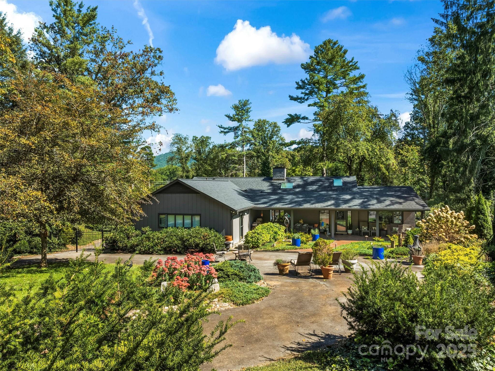 5 Busbee Road Asheville, NC 28803 - Photo 41 of 48 a view of a house with sitting area and garden
