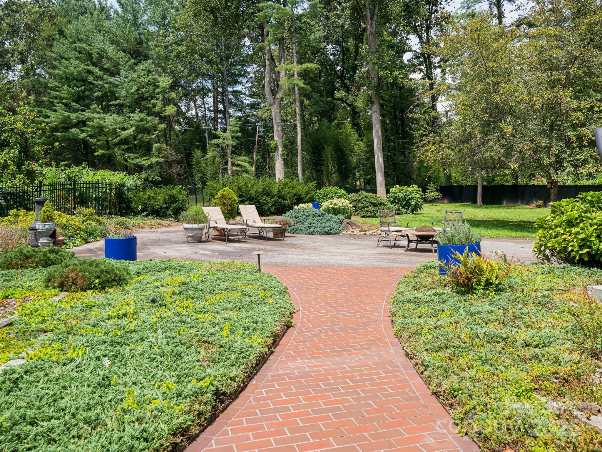 5 Busbee Road Asheville, NC 28803 - Photo 44 of 48 a view of a backyard with plants and patio