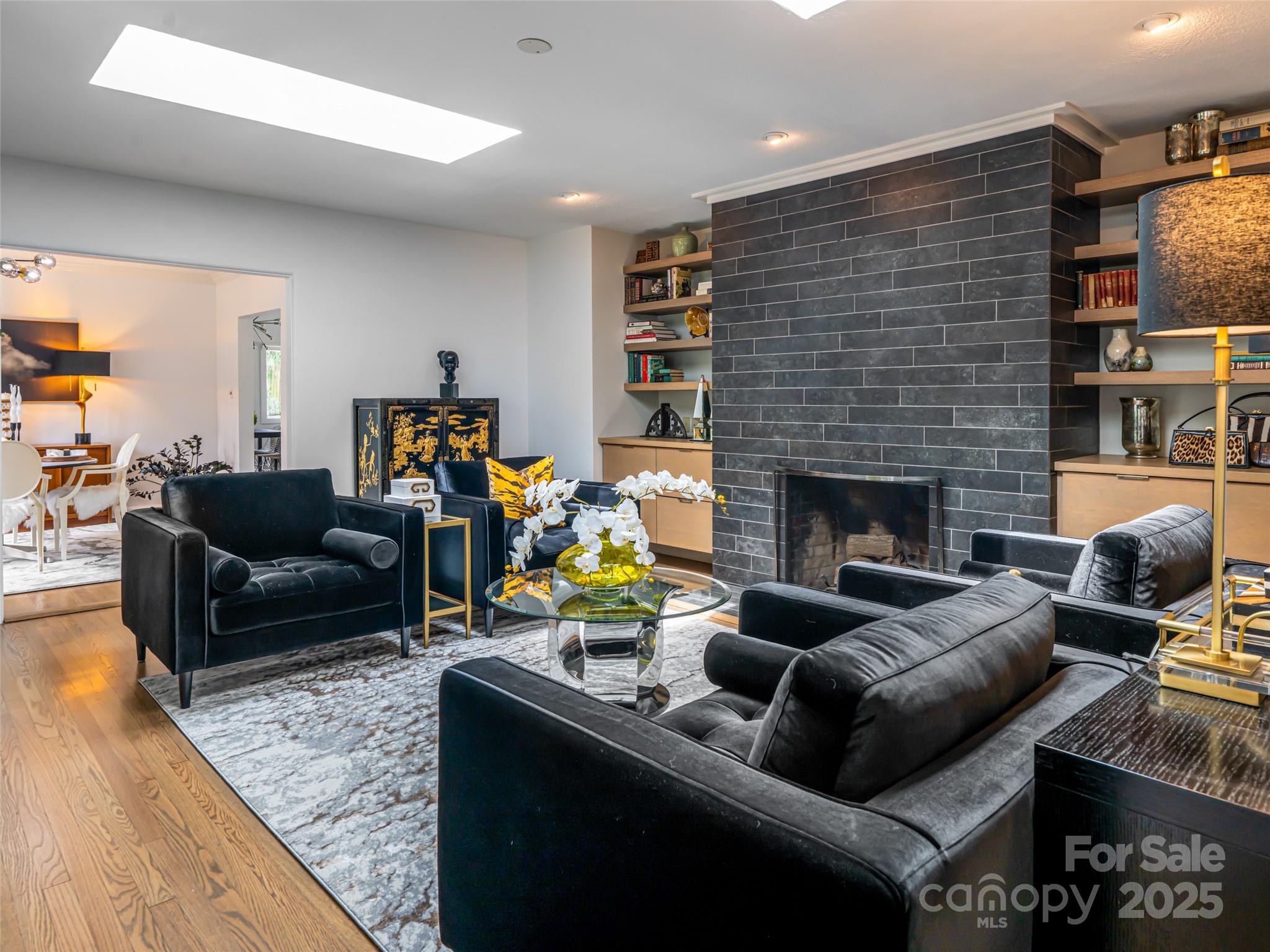 5 Busbee Road Asheville, NC 28803 - Photo 6 of 48 a living room with furniture a fireplace and a flat screen tv