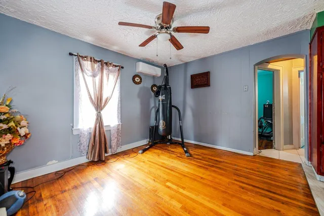 a view of a livingroom with a window and a ceiling fan