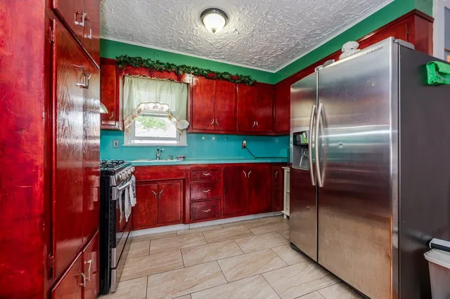 a kitchen with a refrigerator and a sink