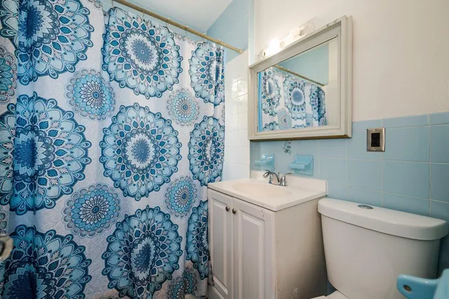 a bathroom with a sink toilet and mirror