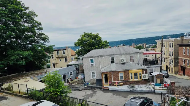 an aerial view of multiple houses with a yard