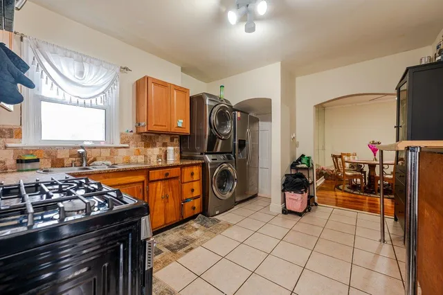 a view of a kitchen with fridge stove and furniture