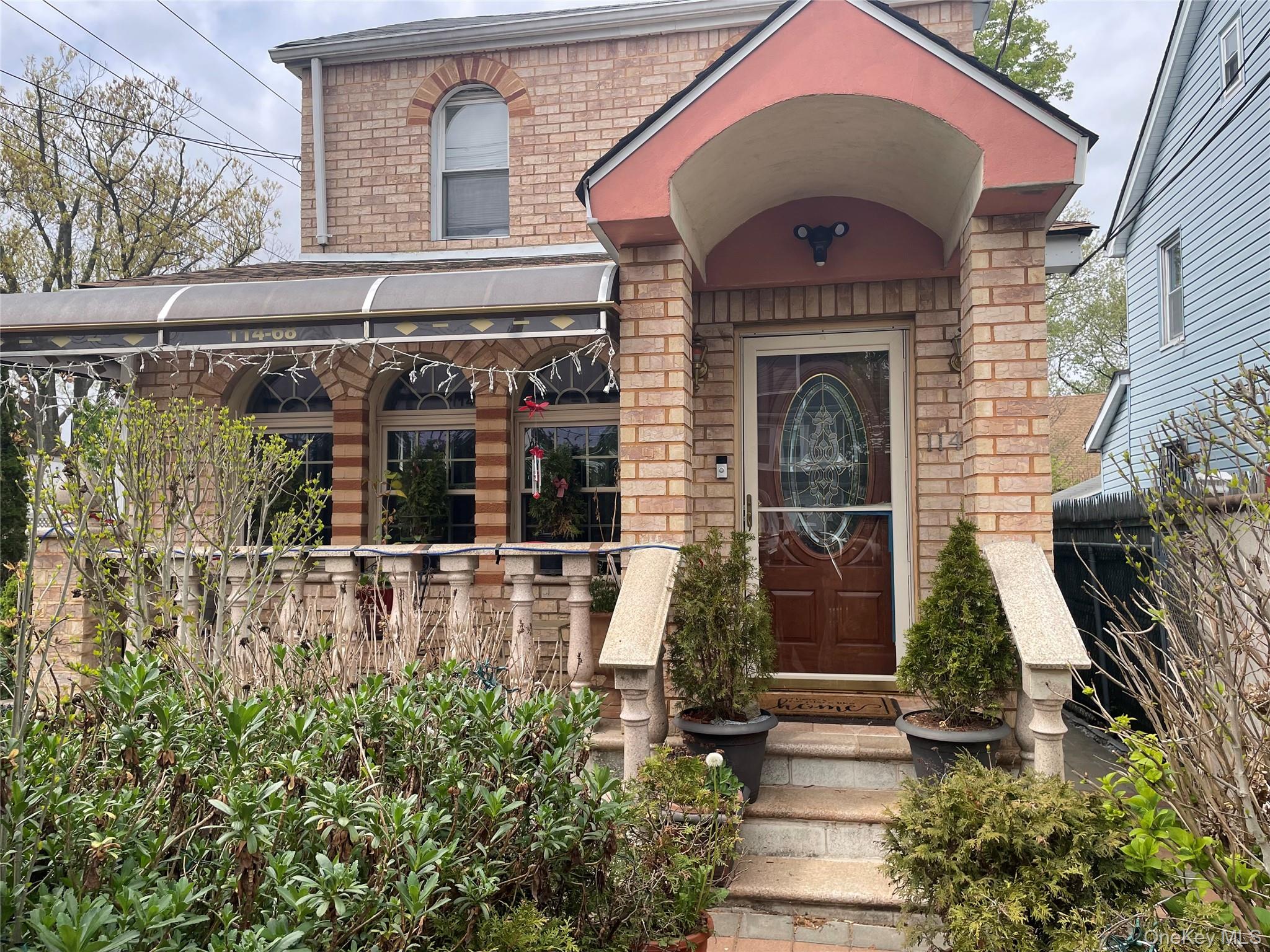 a front view of a house with garden