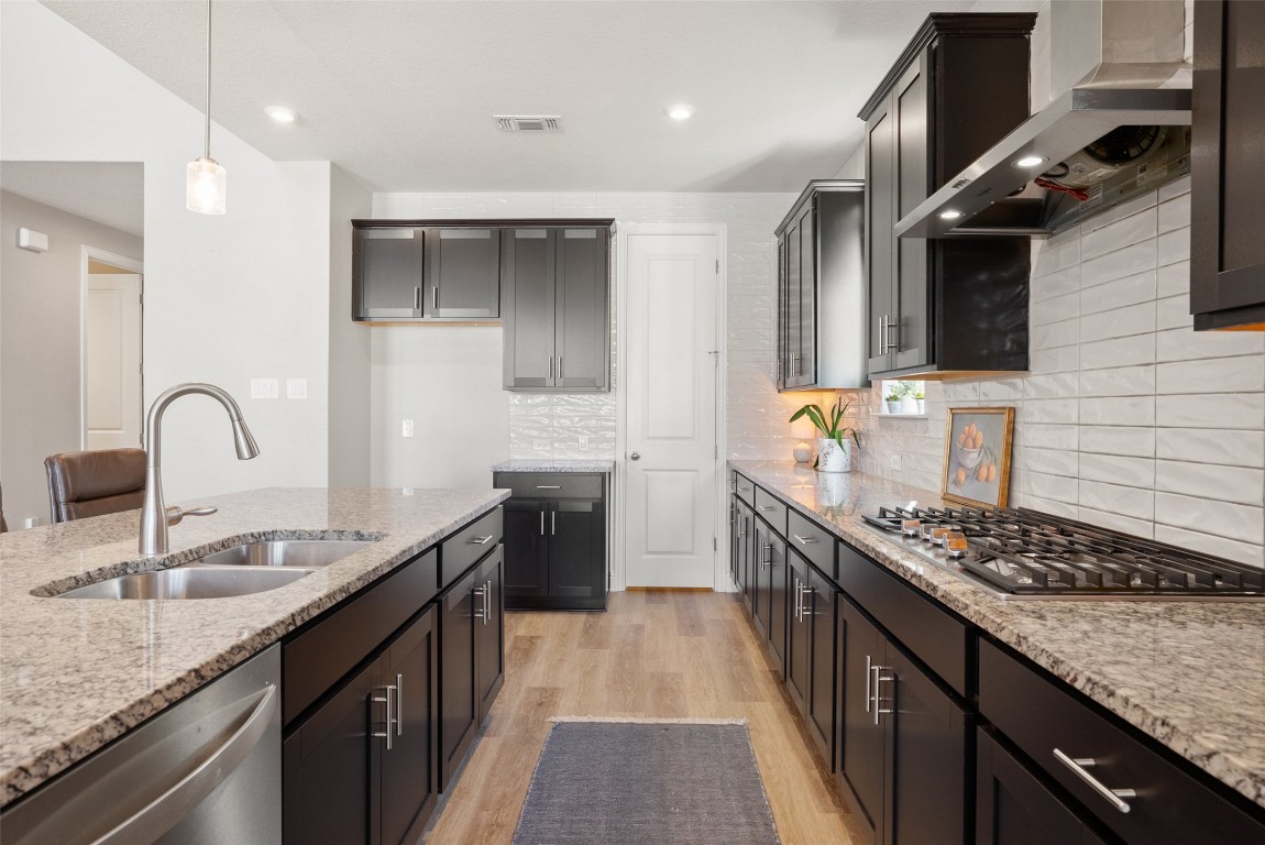 1017 Highcrest Georgetown, TX 78628 - Photo 15 of 40 a kitchen with stainless steel appliances granite countertop a sink stove and cabinets