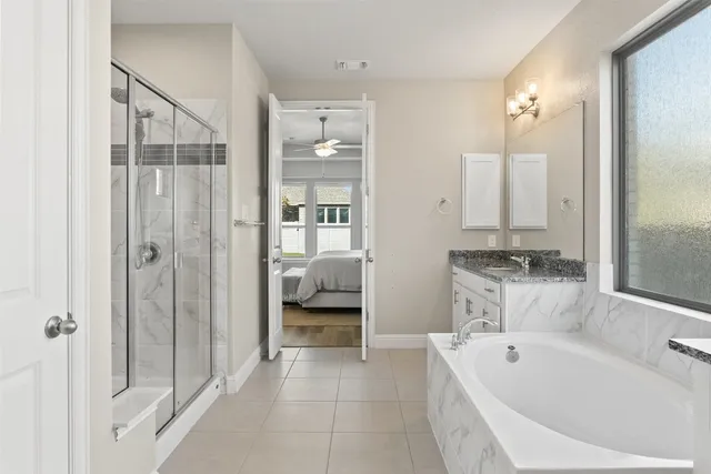 a bathroom with a tub a sink and mirrors