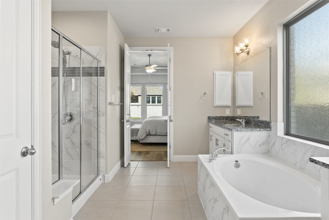 1017 Highcrest Georgetown, TX 78628 - Photo 20 of 40 a bathroom with a tub a sink and mirrors