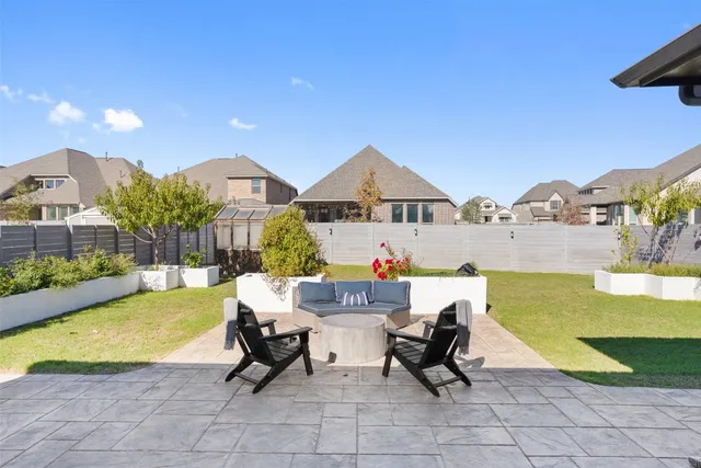 a swimming pool with outdoor seating and yard