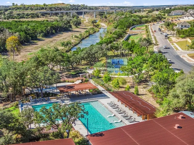 an aerial view of a house with a yard and lake view