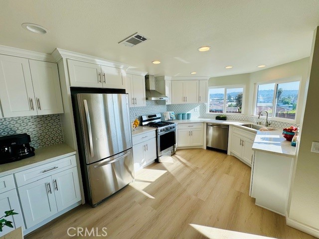 194 Amberwood Drive Walnut, CA 91789 - Photo 10 of 63 a kitchen with white cabinets and stainless steel appliances