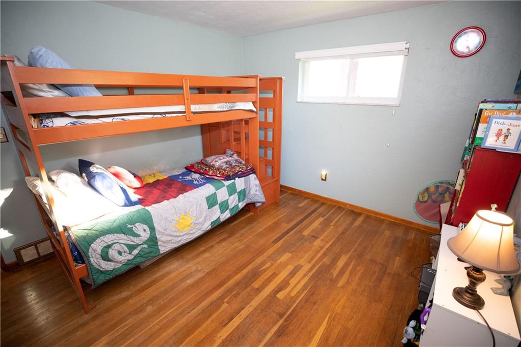 133 Church Road Pittsburgh, PA 15209 - Photo 17 of 20 a bedroom with a bed and a wooden floor