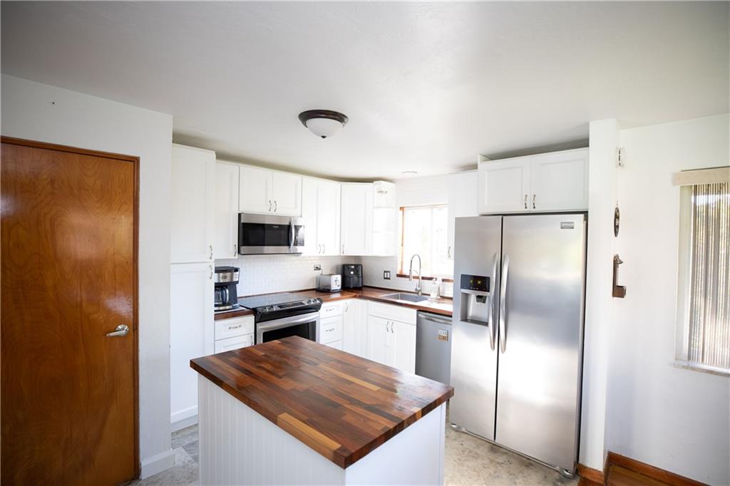 133 Church Road Pittsburgh, PA 15209 - Photo 8 of 20 a kitchen with stainless steel appliances granite countertop a refrigerator a stove a sink and a microwave
