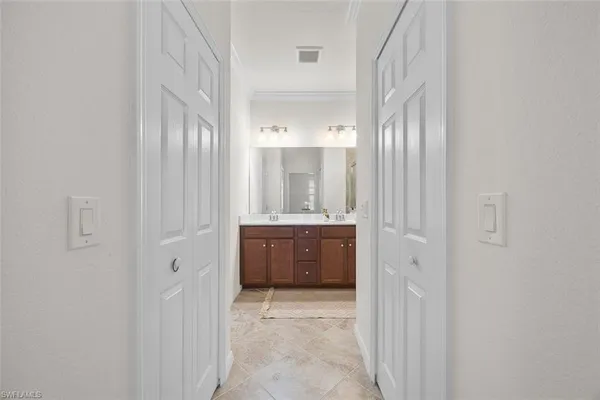 a bathroom with a double vanity sink and mirror
