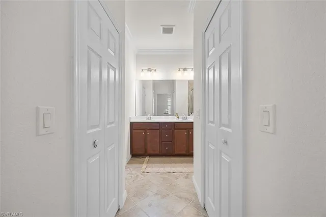 a bathroom with a double vanity sink and mirror