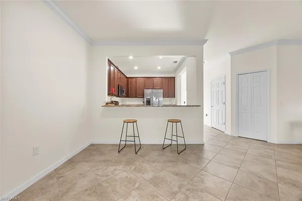 a view of kitchen with stainless steel appliances refrigerator sink and cabinets