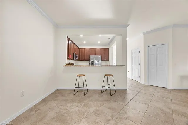 a view of kitchen with stainless steel appliances refrigerator sink and cabinets