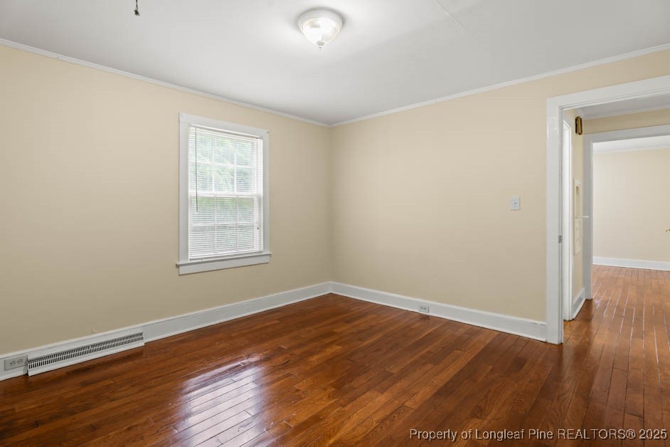 1007 Jenkins Street Lumberton, NC 28358 - Photo 28 of 44 an empty room with wooden floor and windows