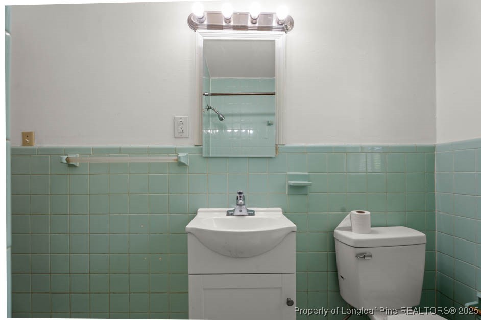1007 Jenkins Street Lumberton, NC 28358 - Photo 30 of 44 a bathroom with a sink a toilet and mirror