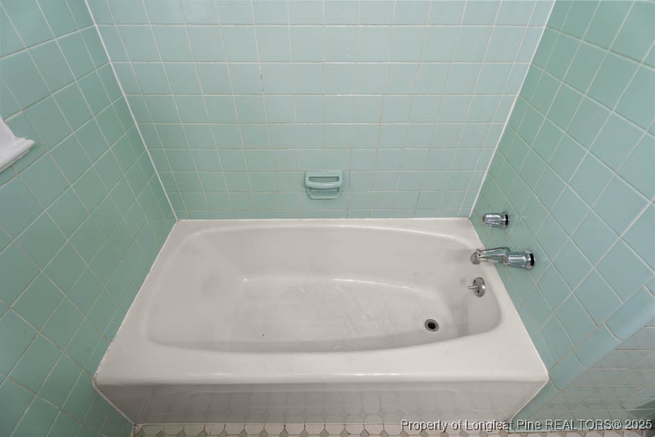 1007 Jenkins Street Lumberton, NC 28358 - Photo 31 of 44 a white bath tub sitting in a bathroom