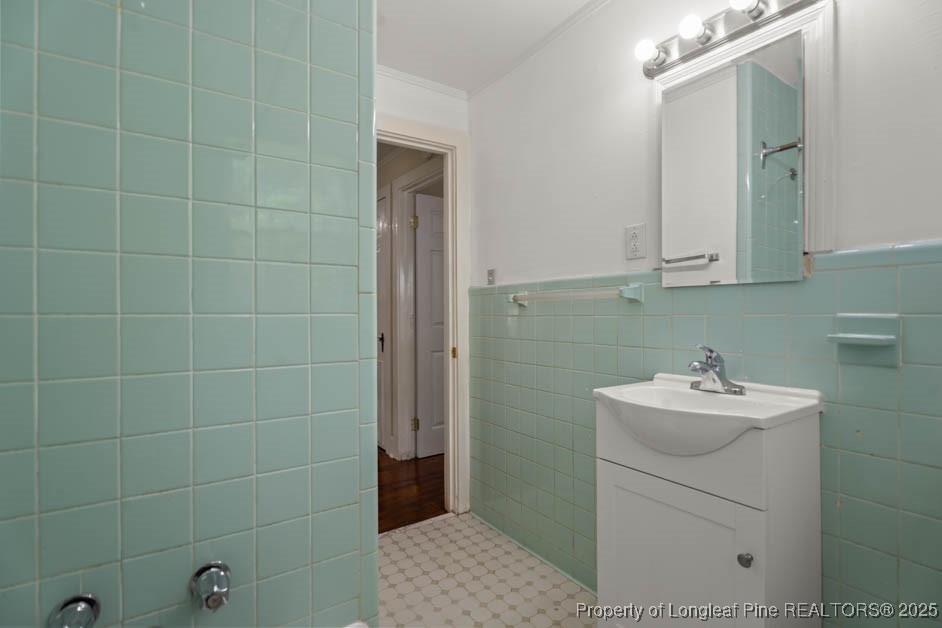 1007 Jenkins Street Lumberton, NC 28358 - Photo 32 of 44 a bathroom with a sink a toilet and mirror
