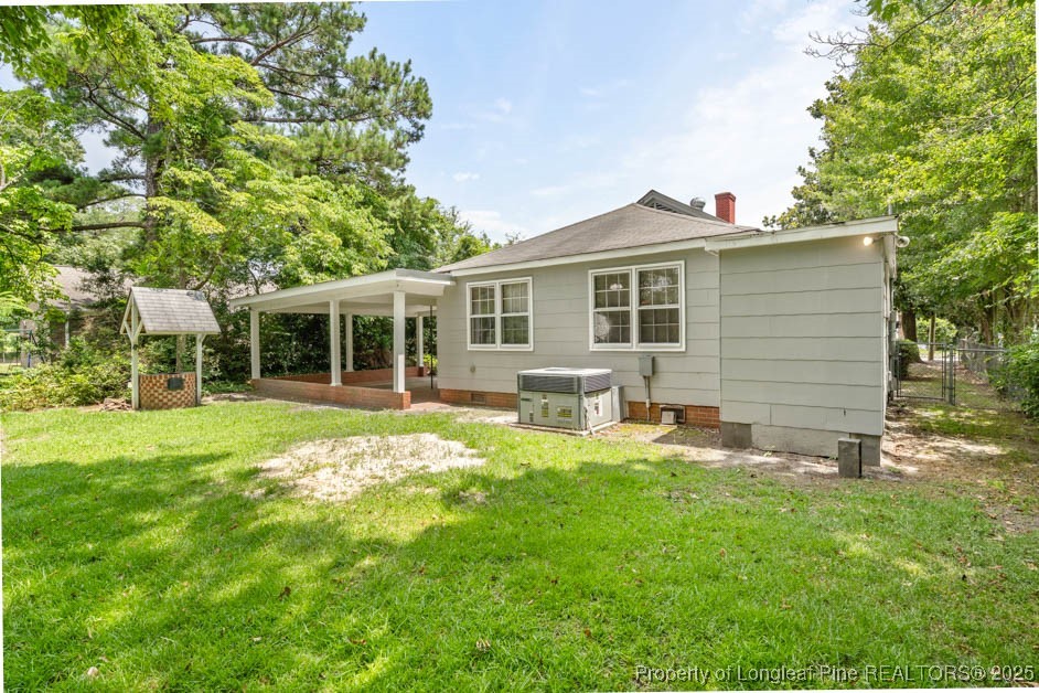 1007 Jenkins Street Lumberton, NC 28358 - Photo 38 of 44 a backyard of a house with table and chairs