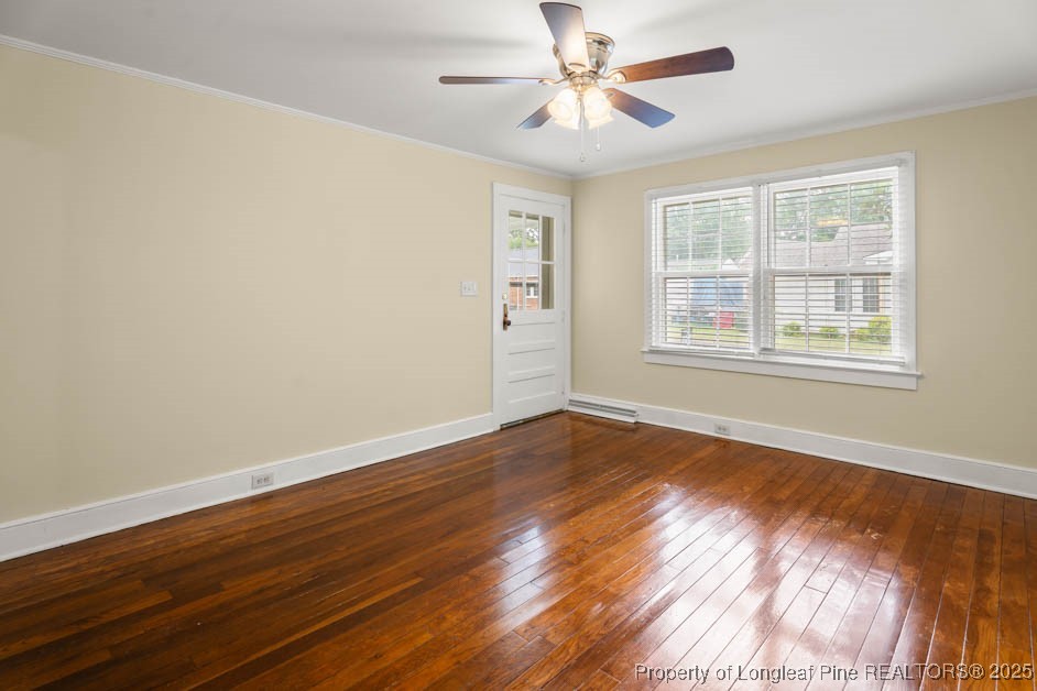 1007 Jenkins Street Lumberton, NC 28358 - Photo 7 of 44 a view of an empty room with wooden floor and a window