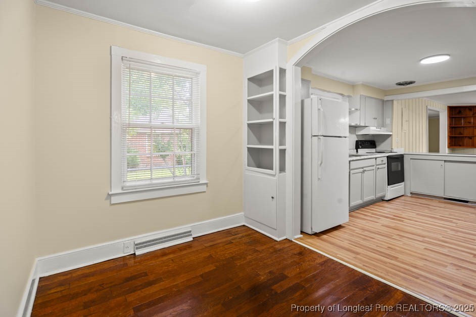 1007 Jenkins Street Lumberton, NC 28358 - Photo 9 of 44 a view of a kitchen with wooden floor and windows