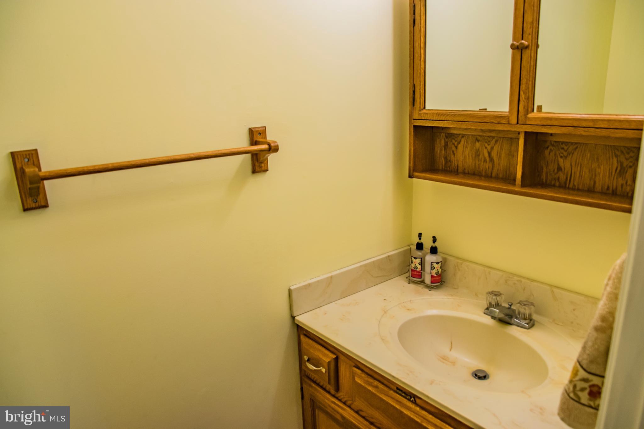 1403 Spring Avenue Baltimore, MD 21237 - Photo 11 of 28 a bathroom with a sink and mirror