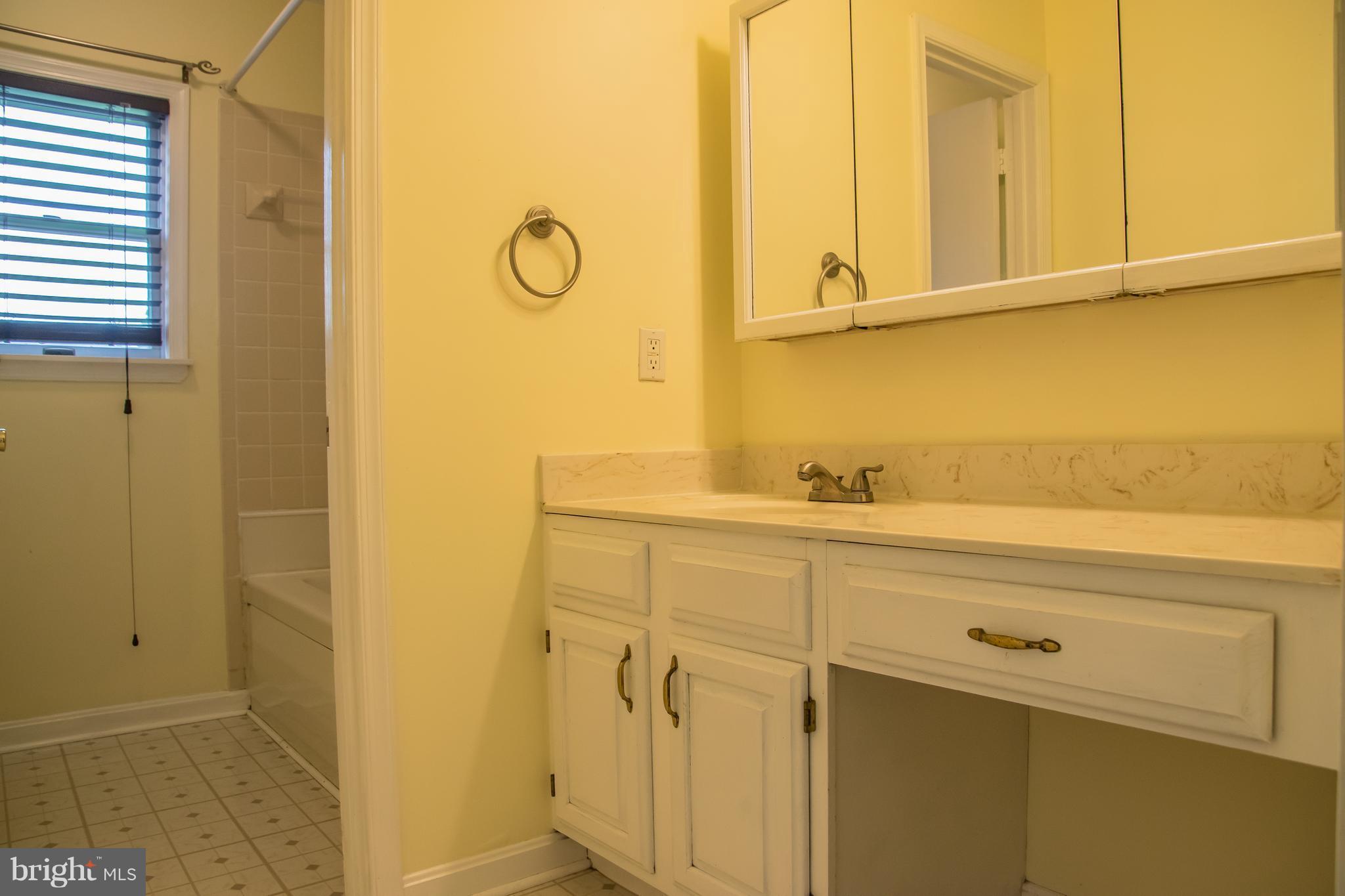 1403 Spring Avenue Baltimore, MD 21237 - Photo 13 of 28 a bathroom with a sink and a mirror