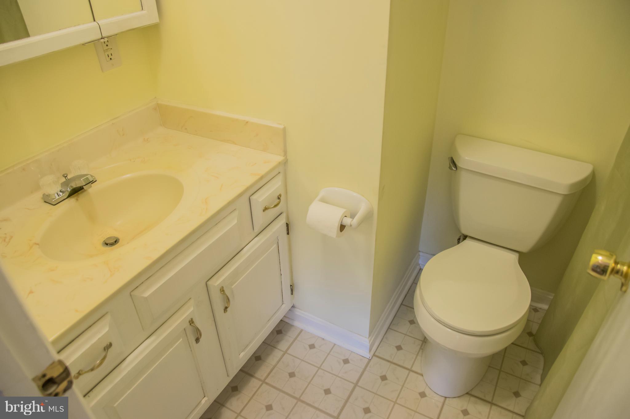 1403 Spring Avenue Baltimore, MD 21237 - Photo 20 of 28 a bathroom with a granite countertop toilet and a sink