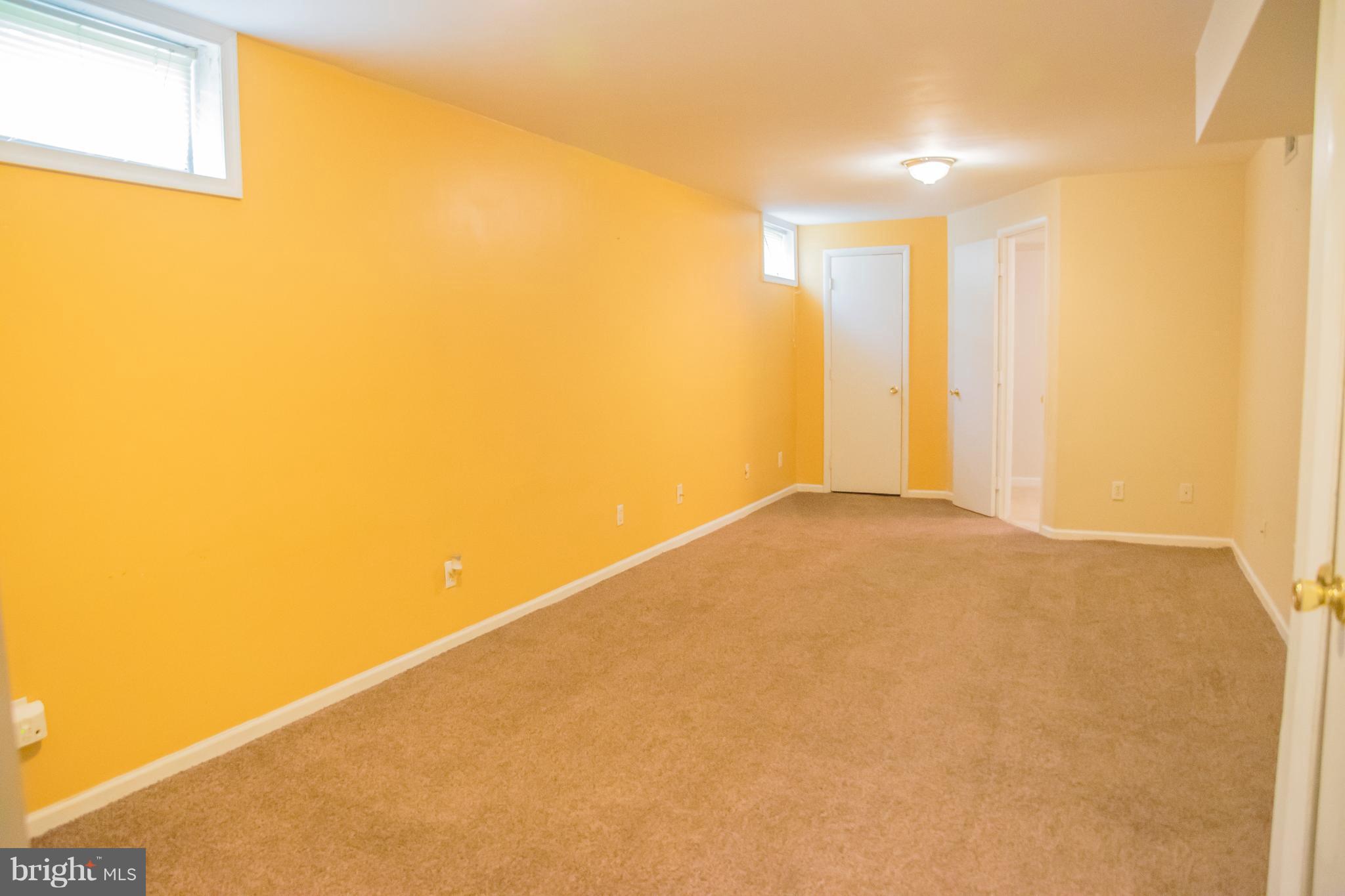 1403 Spring Avenue Baltimore, MD 21237 - Photo 22 of 28 a view of a big room with wooden floor and windows