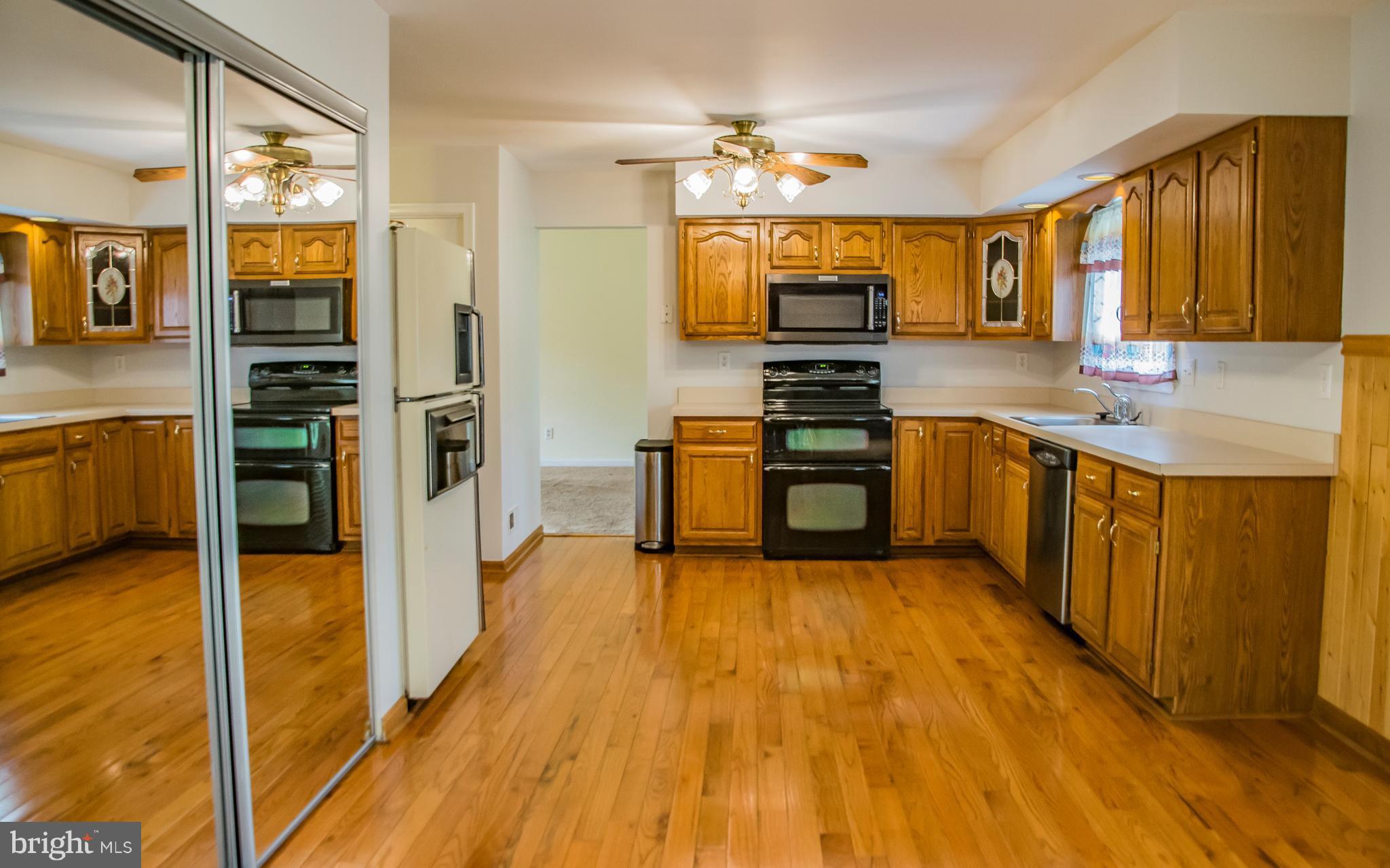 1403 Spring Avenue Baltimore, MD 21237 - Photo 5 of 28 a large kitchen with stainless steel appliances a large counter top space and stainless steel appliances