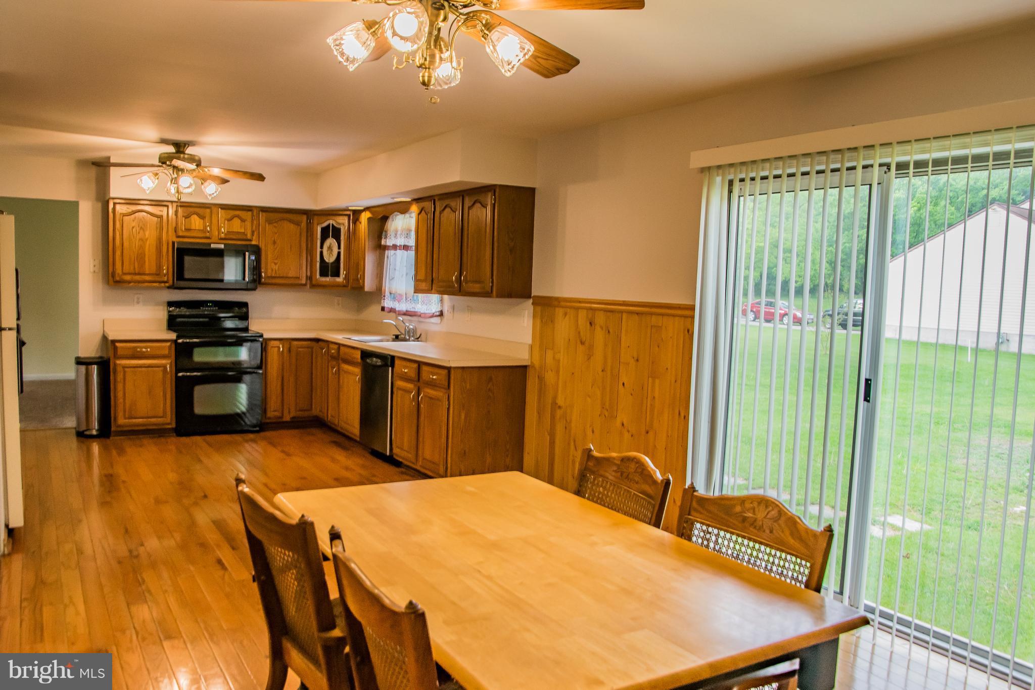 1403 Spring Avenue Baltimore, MD 21237 - Photo 7 of 28 a kitchen with kitchen island a stove a sink and a refrigerator