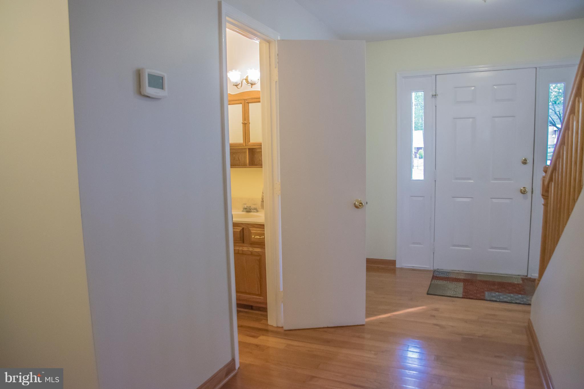 1403 Spring Avenue Baltimore, MD 21237 - Photo 10 of 28 an empty room with wooden floor and windows